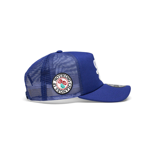 "NOTHING CHANGES" NEW ERA 9FORTY TRUCKER CAP [ROYAL BLUE]